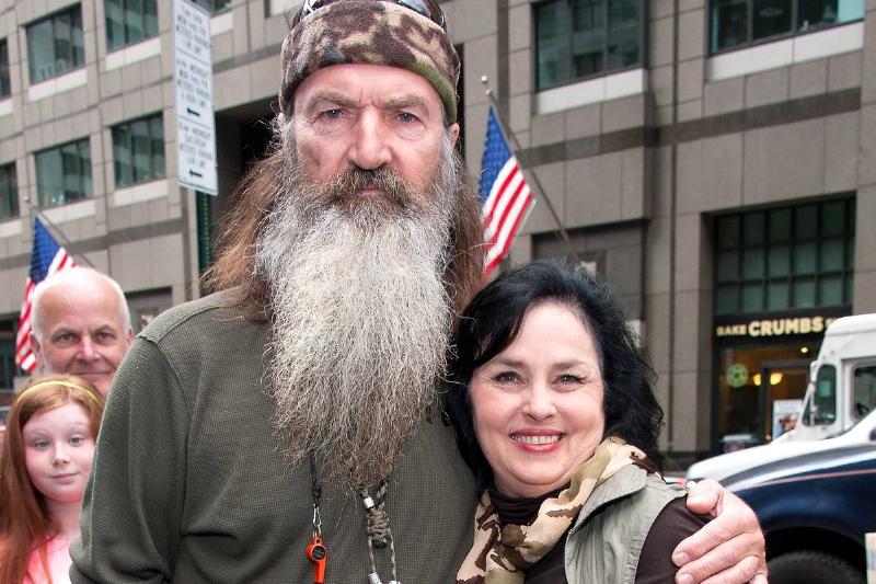Phil Robertson poses with his wife in a public setting