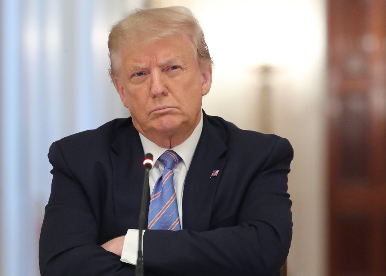 Donald Trump pouts with arms crossed
