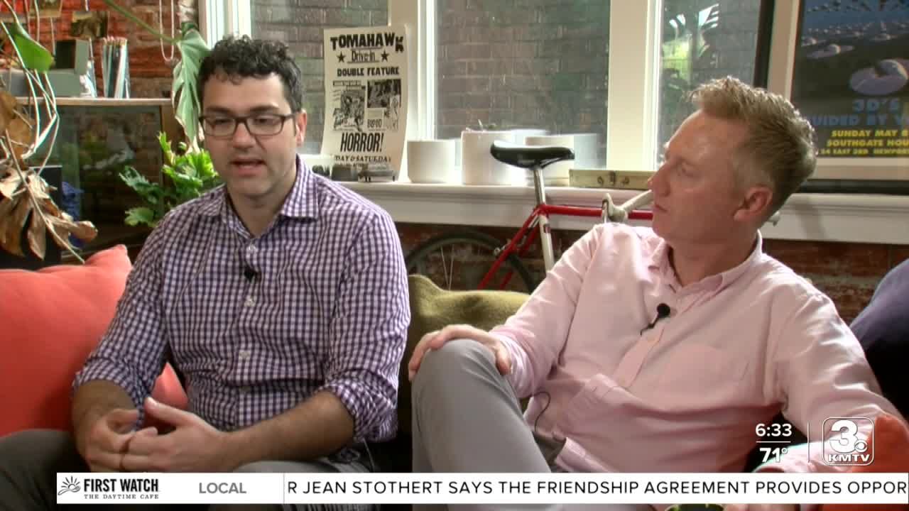A man sits with Matt Wynn in an interview on local television